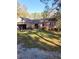 Charming brick home featuring a well-maintained lawn and attached garage at 6340 Koweta Rd, Fairburn, GA 30213