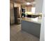 Modern kitchen with gray island, stainless steel appliances, and granite countertops at 6340 Koweta Rd, Fairburn, GA 30213
