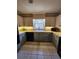 Bright kitchen featuring tile floors, updated cabinets, and stylish countertops at 6340 Koweta Rd, Fairburn, GA 30213