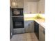 Modern kitchen with white and grey cabinets, stainless steel appliances, and lots of counter space at 6340 Koweta Rd, Fairburn, GA 30213