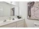 Well-lit bathroom featuring a large mirror, white cabinets, and tasteful decor for a serene and functional space at 1634 Ponce De Leon Ne Ave # 514, Atlanta, GA 30307