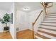 Inviting foyer featuring hardwood floors, a staircase with white risers, and a coat closet at 1634 Ponce De Leon Ne Ave # 514, Atlanta, GA 30307