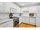 Bright kitchen featuring stainless appliances, white cabinets, white subway tile backsplash, and hardwood floors at 1634 Ponce De Leon Ne Ave # 514, Atlanta, GA 30307