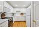 Bright kitchen featuring stainless appliances, white cabinets, white subway tile backsplash, and hardwood floors at 1634 Ponce De Leon Ne Ave # 514, Atlanta, GA 30307