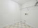 Efficient laundry room with checkerboard tile floor and a shelf for storage to make laundry tasks easier at 1634 Ponce De Leon Ne Ave # 514, Atlanta, GA 30307