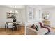 Bright living room featuring hardwood floors, neutral decor, a modern sofa, and a view into the dining area at 1634 Ponce De Leon Ne Ave # 514, Atlanta, GA 30307