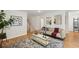 Bright living room featuring hardwood floors, neutral decor, a modern sofa, and a view into the entry at 1634 Ponce De Leon Ne Ave # 514, Atlanta, GA 30307