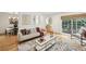 Bright living room featuring hardwood floors, neutral decor, a modern sofa, and a view into the backyard at 1634 Ponce De Leon Ne Ave # 514, Atlanta, GA 30307