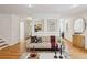 Bright living room featuring hardwood floors, neutral decor, a modern sofa, and a view into the dining area at 1634 Ponce De Leon Ne Ave # 514, Atlanta, GA 30307