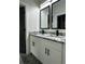 Modern bathroom with dual vanities, granite countertops, and black fixtures at 1962 Compton Se Dr, Atlanta, GA 30315