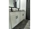 Modern bathroom with white cabinets, granite countertops, and black fixtures at 1962 Compton Se Dr, Atlanta, GA 30315