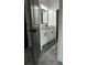 Bathroom with white cabinets, granite countertops, and gray tile flooring at 1962 Compton Se Dr, Atlanta, GA 30315