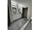 Bathroom with dual vanity, tiled floors, modern fixtures, and neutral paint at 1962 Compton Se Dr, Atlanta, GA 30315
