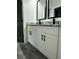 Modern bathroom with dual vanities, granite countertops, and black fixtures at 1962 Compton Se Dr, Atlanta, GA 30315