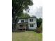 Charming two-story home featuring a welcoming front porch and modern white siding with black trim at 1962 Compton Se Dr, Atlanta, GA 30315