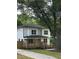 Attractive two-story home with a welcoming front porch, set amid mature trees and a well-kept lawn at 1962 Compton Se Dr, Atlanta, GA 30315