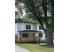 Charming two-story home with a welcoming front porch and mature trees in the yard at 1962 Compton Se Dr, Atlanta, GA 30315