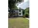 Classic two-story home featuring a charming front porch and an attractive, well-maintained lawn at 1962 Compton Se Dr, Atlanta, GA 30315