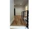 View of the second story hallway with wood floors and a modern rail system at 1962 Compton Se Dr, Atlanta, GA 30315