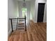 Hallway featuring gleaming hardwood floors and an eye-catching modern black iron railing at 1962 Compton Se Dr, Atlanta, GA 30315