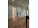 Hallway featuring gleaming hardwood floors and an eye-catching modern black iron railing at 1962 Compton Se Dr, Atlanta, GA 30315