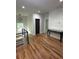 Second story hallway features hardwood floors, modern railings, and a view of the neighborhood through the window at 1962 Compton Se Dr, Atlanta, GA 30315