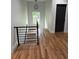 Hallway featuring gleaming hardwood floors and an eye-catching modern black iron railing at 1962 Compton Se Dr, Atlanta, GA 30315