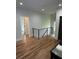 Hallway featuring gleaming hardwood floors and an eye-catching modern black iron railing at 1962 Compton Se Dr, Atlanta, GA 30315