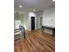 Second story hallway features hardwood floors, modern railings, and a view of the neighborhood through the window at 1962 Compton Se Dr, Atlanta, GA 30315