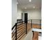View of the second story hallway with wood floors and a modern rail system at 1962 Compton Se Dr, Atlanta, GA 30315