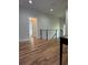 Hallway featuring gleaming hardwood floors and an eye-catching modern black iron railing at 1962 Compton Se Dr, Atlanta, GA 30315