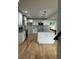 Bright kitchen featuring an island with stone countertop, stainless appliances and hardwood floors at 1962 Compton Se Dr, Atlanta, GA 30315