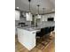 A kitchen with white cabinets, stainless steel appliances and a large island with bar stool seating at 1962 Compton Se Dr, Atlanta, GA 30315