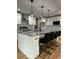 Modern kitchen island featuring barstool seating, granite countertops, and stainless appliances at 1962 Compton Se Dr, Atlanta, GA 30315