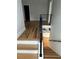 Modern staircase with wood treads, white risers, and black metal railing leading to the kitchen at 1962 Compton Se Dr, Atlanta, GA 30315