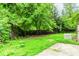 Fenced backyard with mature trees and green lawn at 3133 Cottonwood Se Dr, Atlanta, GA 30316