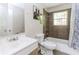 Bathroom featuring a bathtub, toilet, sink and mirror at 3133 Cottonwood Se Dr, Atlanta, GA 30316