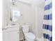 Bathroom with a toilet, vanity, and a shower with a blue striped shower curtain at 3133 Cottonwood Se Dr, Atlanta, GA 30316