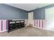 Bedroom with pink and blue stripes and black dresser at 3133 Cottonwood Se Dr, Atlanta, GA 30316