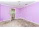 Bedroom featuring light purple walls, damaged flooring, and natural light at 3133 Cottonwood Se Dr, Atlanta, GA 30316
