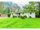 Side view of a single-story home with a large green lawn and mature trees surrounding the property at 3133 Cottonwood Se Dr, Atlanta, GA 30316