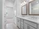 Stylish bathroom with double vanity, framed mirrors, and a tiled shower with a glass door at 334 Olmstead Way # 37, Alpharetta, GA 30022