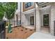 Inviting front entrance with brickwork, covered porch, and modern black door at 334 Olmstead Way # 37, Alpharetta, GA 30022