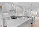 Open kitchen with white cabinets, stainless steel appliances, island, and hardwood floors at 334 Olmstead Way # 37, Alpharetta, GA 30022