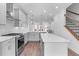 Modern kitchen featuring white cabinetry, stainless steel appliances, and an island for seating at 334 Olmstead Way # 37, Alpharetta, GA 30022