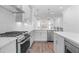 Beautiful kitchen features stainless steel appliances, island seating, white countertops, and hardwood floors at 334 Olmstead Way # 37, Alpharetta, GA 30022
