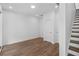 Bright living room featuring hardwood floors, white walls, and staircase to the second floor at 334 Olmstead Way # 37, Alpharetta, GA 30022