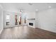 Bright living room with fireplace, wooden floors, ceiling fan, and balcony access at 334 Olmstead Way # 37, Alpharetta, GA 30022