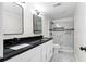 Modern bathroom featuring a double vanity with a sleek black countertop and stylish shower at 6658 Collins Ct, Riverdale, GA 30274