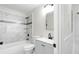 Updated bathroom featuring a shower-over-tub with marble-look tile, sleek vanity, and modern fixtures at 6658 Collins Ct, Riverdale, GA 30274